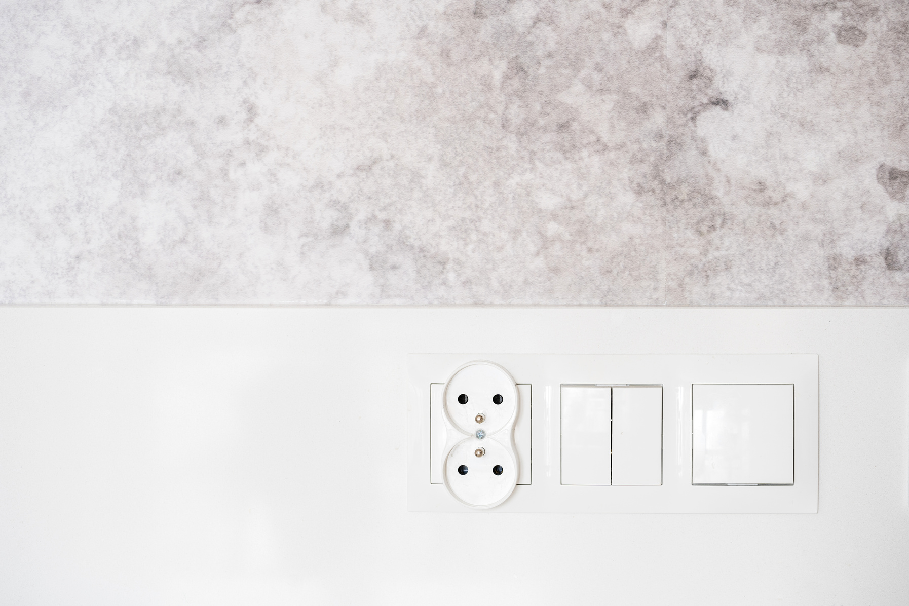 electrical sockets and light switch on wall background